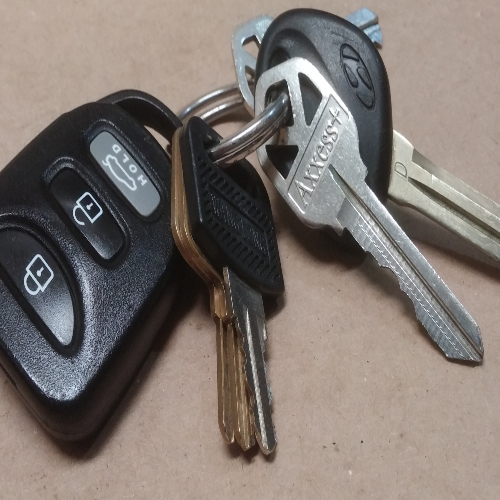 Keys and fob on a desk.